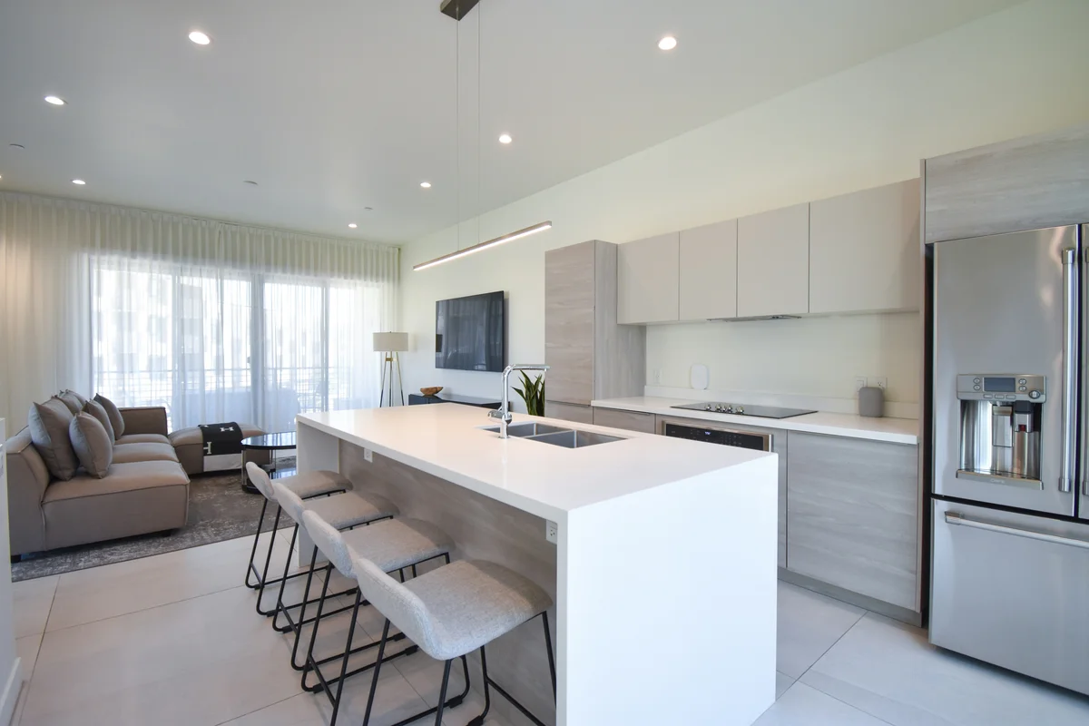 Modern open-plan kitchen and living area with island counter and bar seating